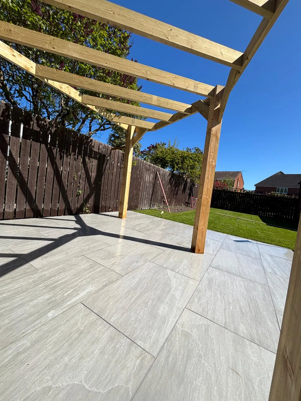 Paved patio with a newly built timber pergola