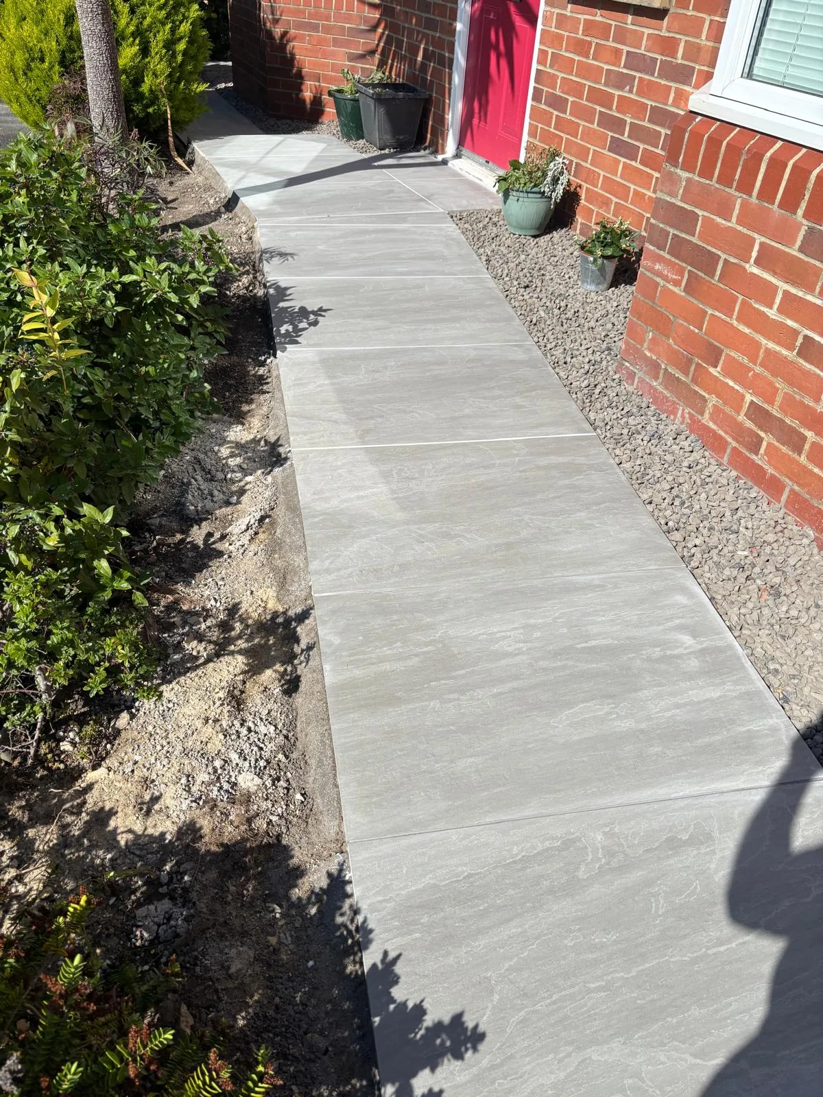 Large-format paved path beside a planted border